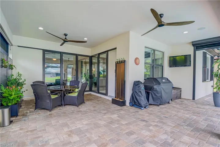 Zero-edge doors to the outside covered lanai area with plenty of space for tables and bbq's! Electric Hurricane Storm Shutters for protection.