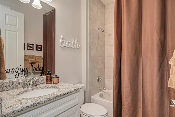 2nd Bathroom featuring vanity and shower / tub combo