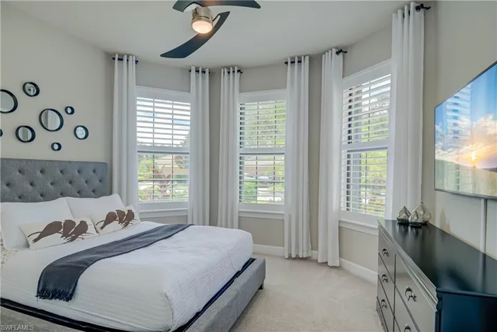 Bedroom featuring light carpet is being replaced,  and a ceiling fan