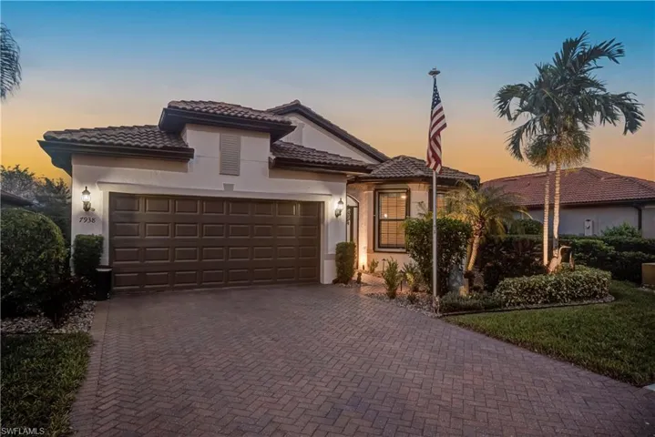 Front of the home is screened-in, bay windows in the front room, oversized 2+garage, tile roof, and lush landscaping