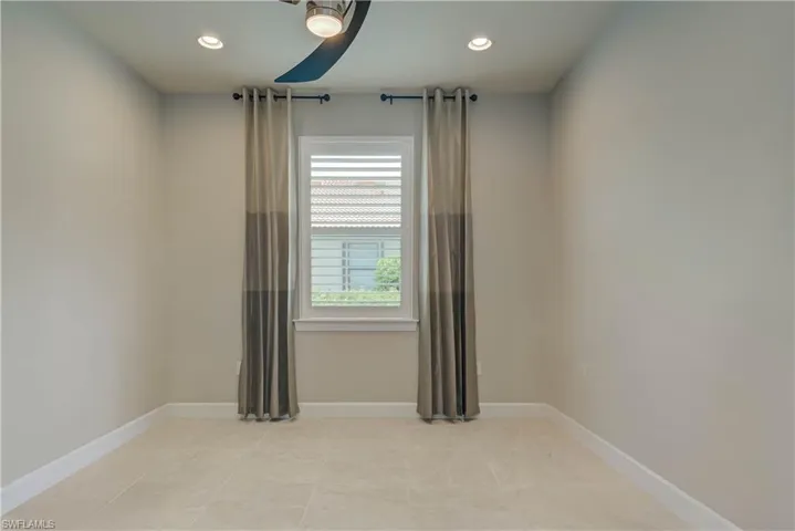 Empty room with recessed lighting, a ceiling fan, and light tile patterned floors. The den could be converted into a bedroom if desired. New French doors