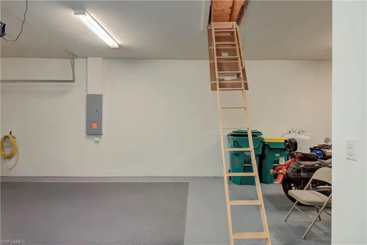 Garage features 2+ spaces and additional room for a golf cart or motorcycles, pull-down ladder to attic for extra storage