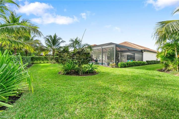 Gorgeous rearview of the home, highlighting the grass and landscaping.