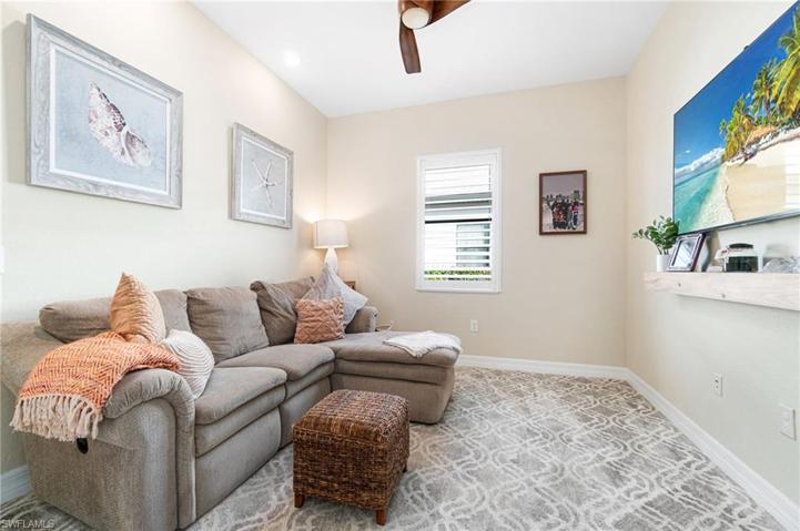 The den is located right off of the main entry, and maintains natural light with a window and glass-pane double doors.