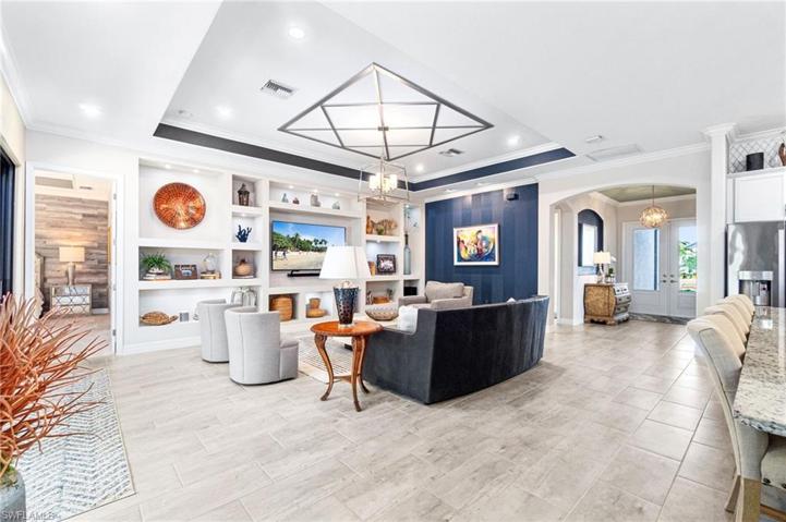 Living area highlighting the grand entryway with 3/4 inch glass panel front doors.