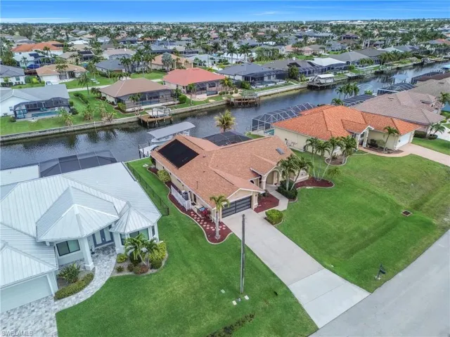 Aerial perspective of suburban area featuring a large body of water