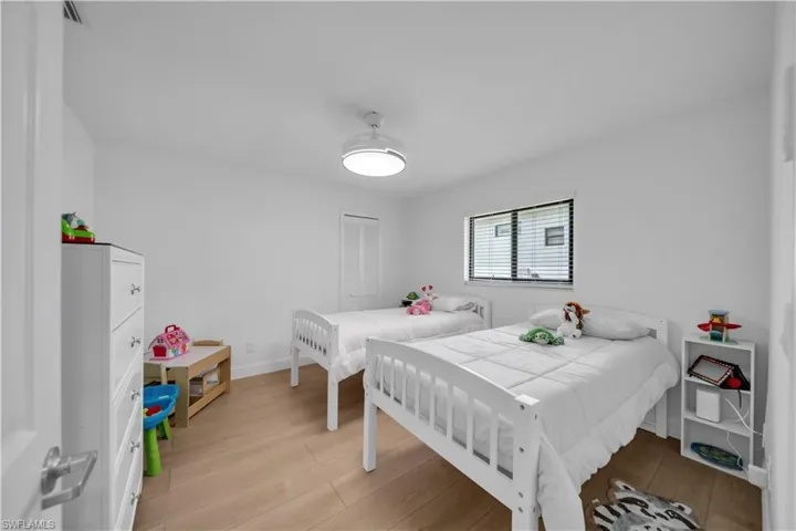 Bedroom featuring light wood-style floors and a closet
