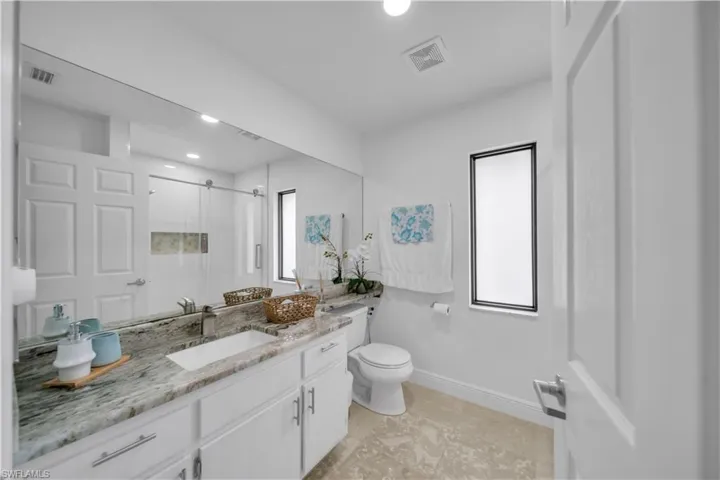 Bathroom featuring a stall shower and vanity