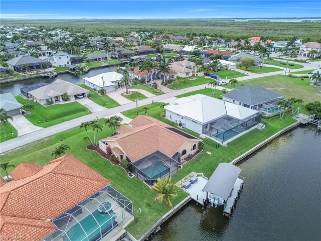 Aerial perspective of suburban area featuring a nearby body of water