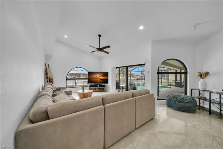 Living area featuring recessed lighting, a ceiling fan, and vaulted ceiling