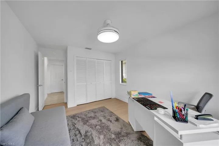 Office space with light wood-style flooring and baseboards