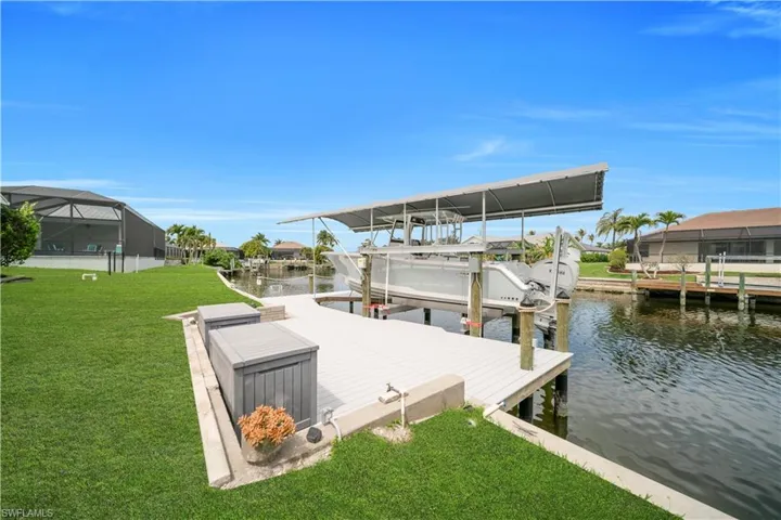 Dock area featuring a yard, a water view, and boat lift