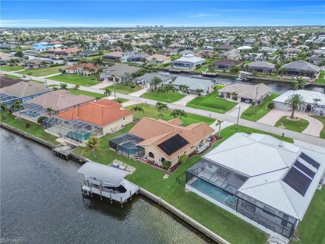 Aerial view of residential area featuring a large body of water