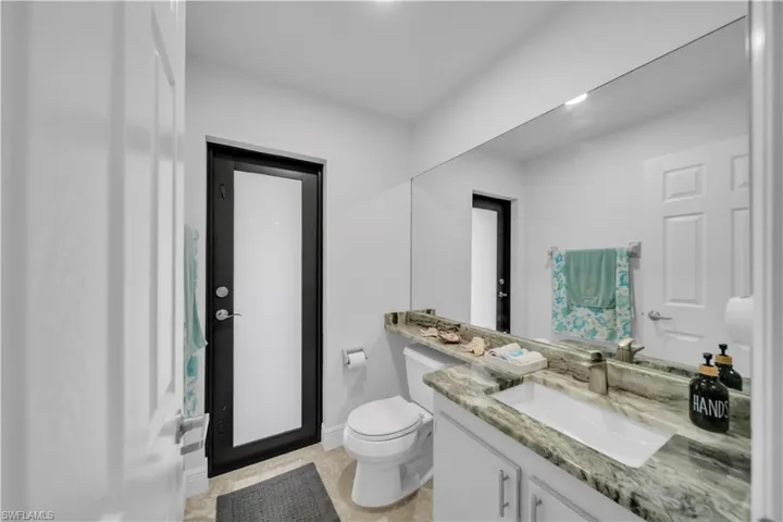 Half bathroom with vanity and toilet