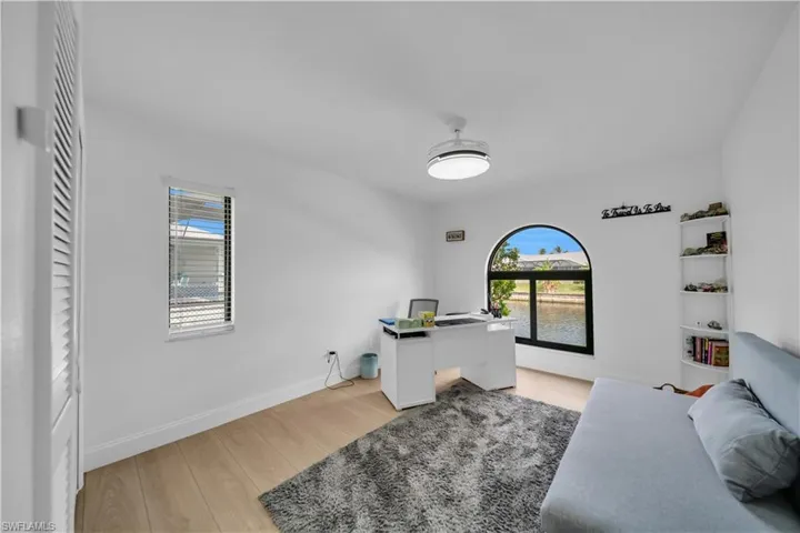 Office area featuring light wood-style flooring and baseboards