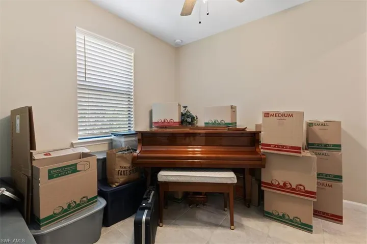 Misc room featuring ceiling fan and light tile flooring