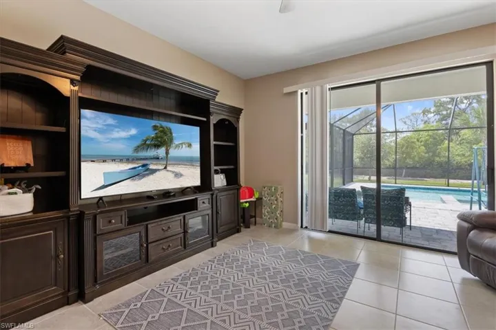 Tiled living room featuring built in shelves
