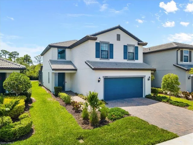 Front facade with a garage and a front lawn