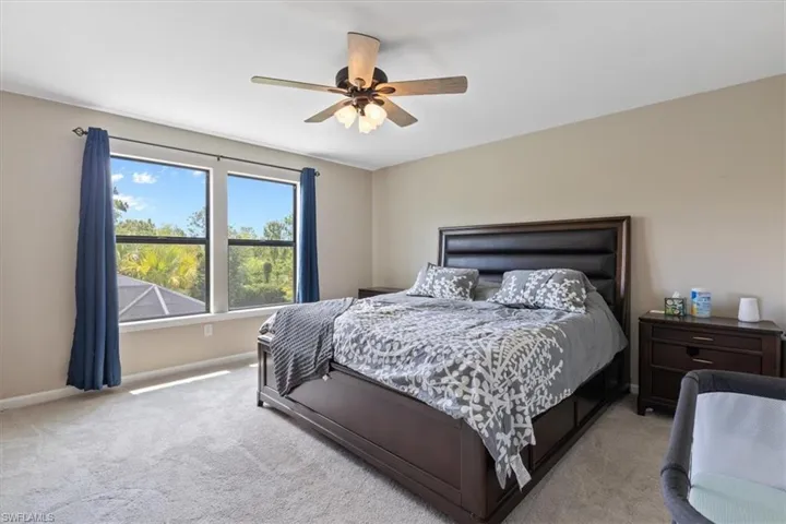 Carpeted bedroom with ceiling fan
