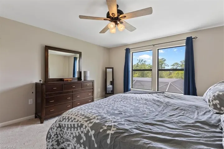 Bedroom featuring light colored carpet and ceiling fan