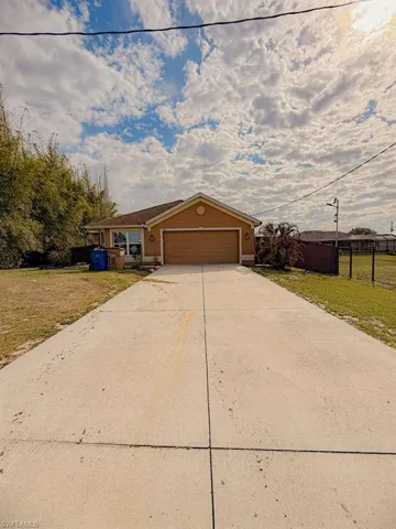 View of front of home featuring a garage and concrete driveway