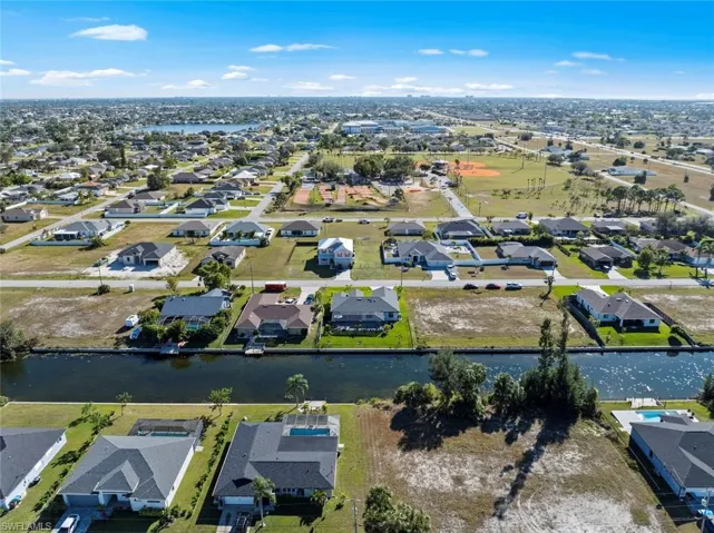 Birds eye view of property with a water view