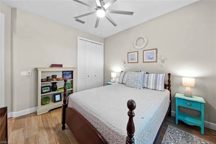 Bedroom with wood-type flooring, a closet, and ceiling fan