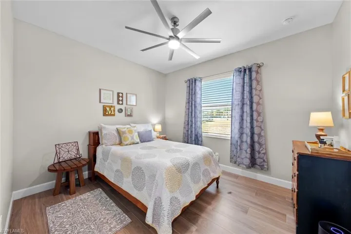 Bedroom with hardwood / wood-style flooring and ceiling fan