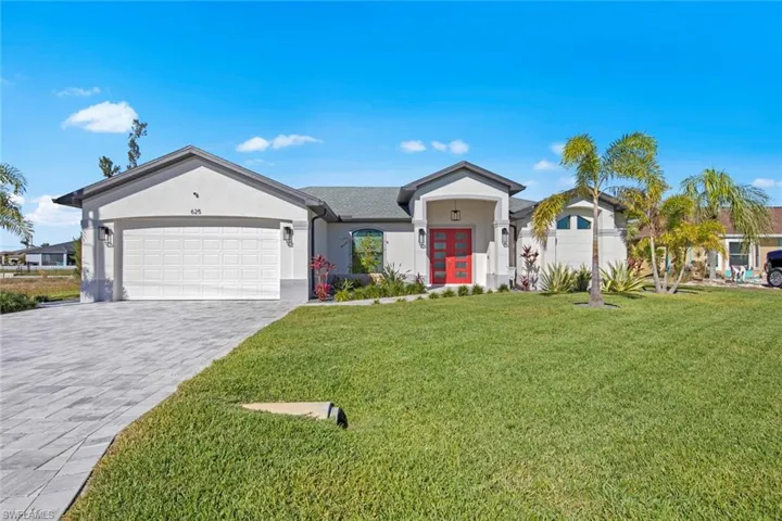 Ranch-style home with a front yard and a garage