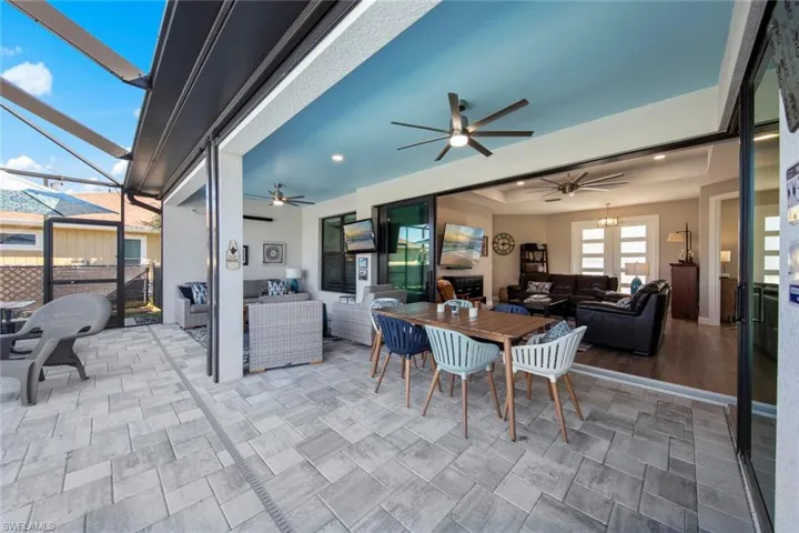 View of patio / terrace with glass enclosure, ceiling fan, and an outdoor hangout area