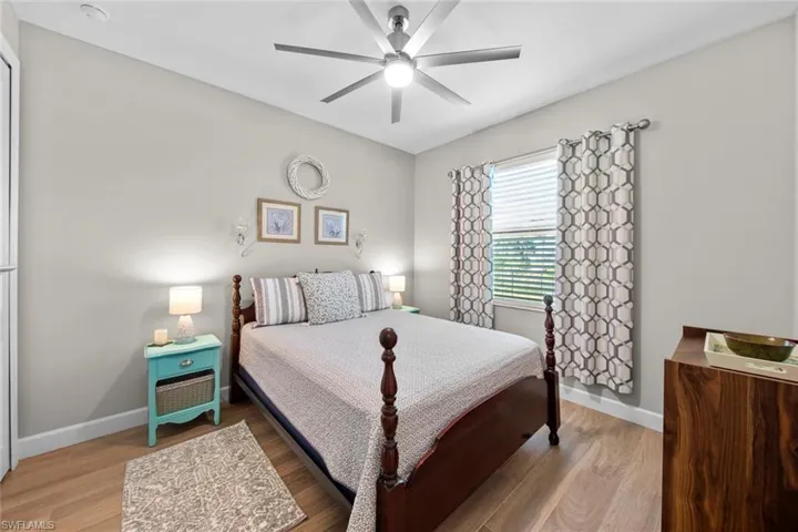 Bedroom featuring ceiling fan and hardwood / wood-style flooring