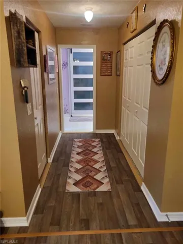 Master hallway with his/her closets leading to Master bath