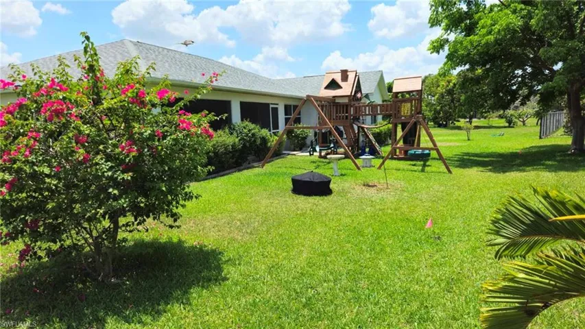Backyard with play set and fire pit