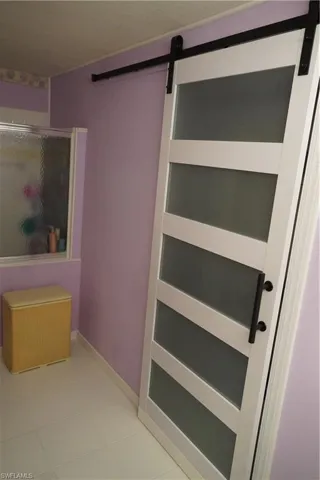 Master bathroom barndoor leading to closet