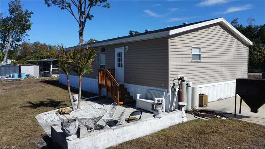 Rear view of property with a patio area and a yard