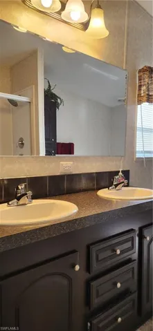 Bathroom with double vanity and a shower stall