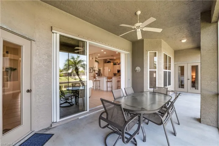 Rear screened in lanai with door to guest bathroom and pocket sliders to great room and French doors to master bedroom