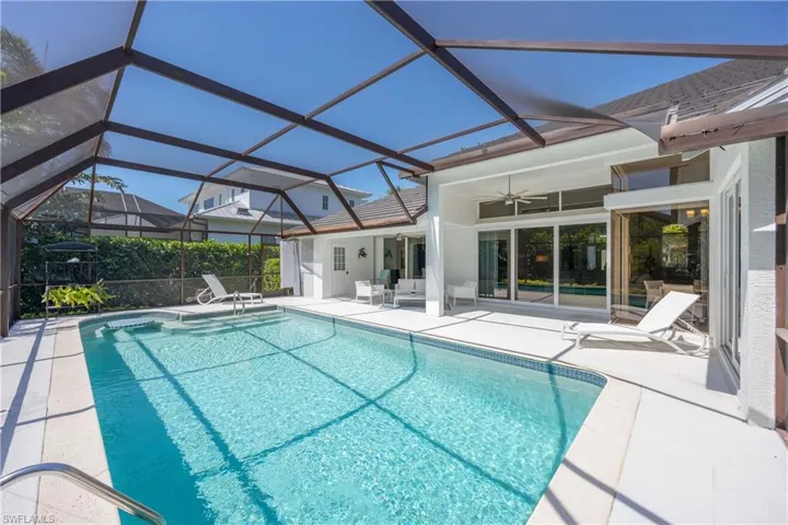 Outdoor pool featuring ceiling fan and a patio