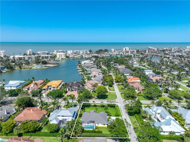 Birds eye view of property with a water view and a residential view