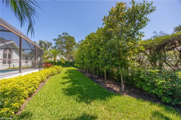 View of yard with an outdoor pool and a lanai