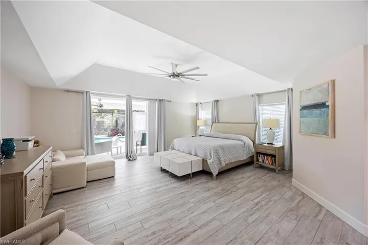 Bedroom featuring a ceiling fan, light wood-style flooring, access to outside, and baseboards