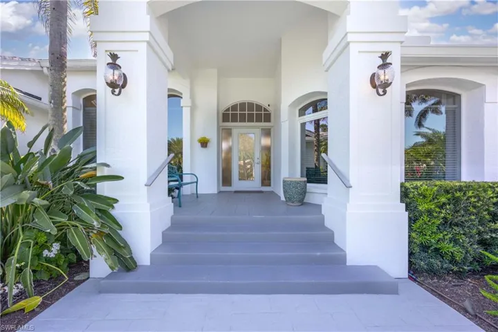View of exterior entry featuring stucco siding and a porch