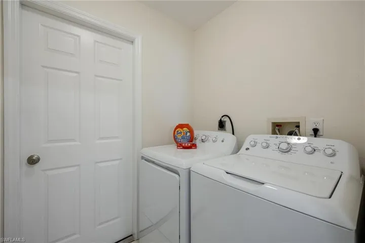 Clothes washing area featuring washing machine and dryer