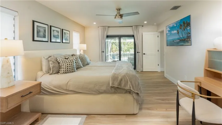 Bedroom featuring ceiling fan, access to outside, and light hardwood / wood-style flooring