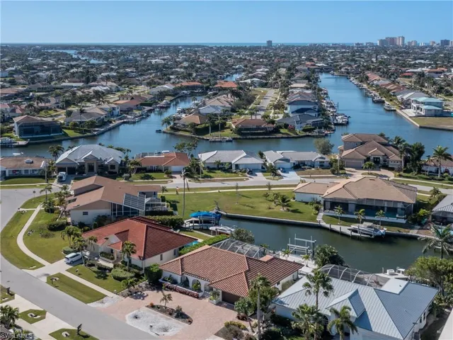 Birds eye view of property with a water view