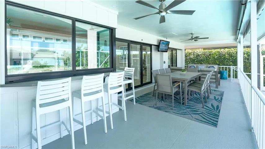 View of patio / terrace featuring ceiling fan and an outdoor bar