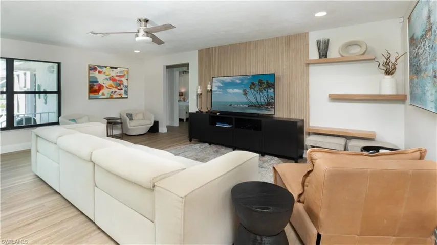 Living room featuring ceiling fan and light wood-type flooring