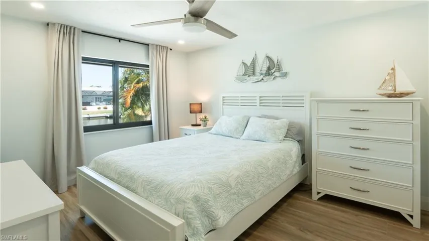 Bedroom featuring ceiling fan and dark wood-type flooring