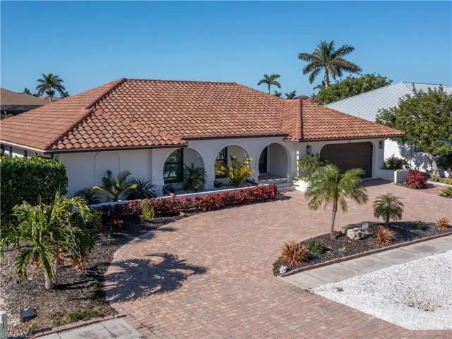 Mediterranean / spanish home featuring a garage
