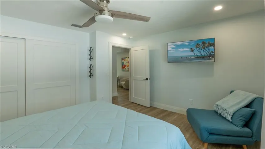 Bedroom featuring ceiling fan, light wood-type flooring, and a closet